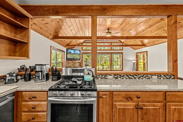 a stove top oven sitting inside of a kitchen