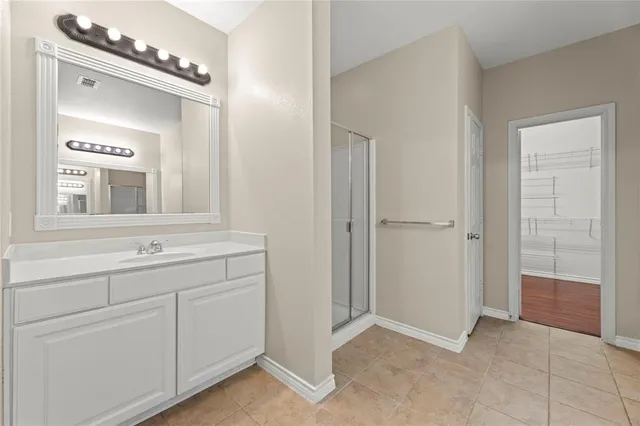 a bathroom with a sink a mirror and a vanity