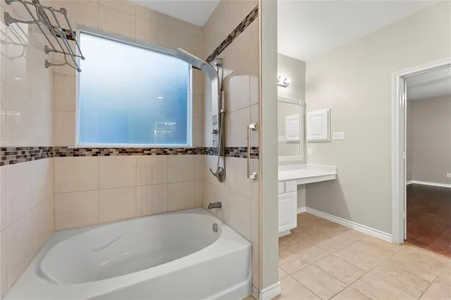 a bathroom with a bathtub and a shower