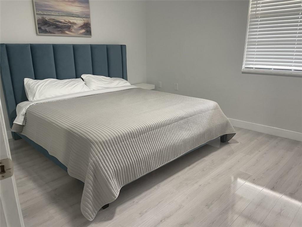 1721 Whitehall Drive, Unit 404 Davie, FL 33324 - Photo 11 of 16 a bed sitting in a bedroom next to a window