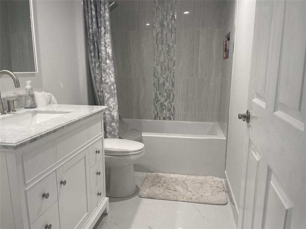 1721 Whitehall Drive, Unit 404 Davie, FL 33324 - Photo 12 of 16 a bathroom with a sink a toilet and shower