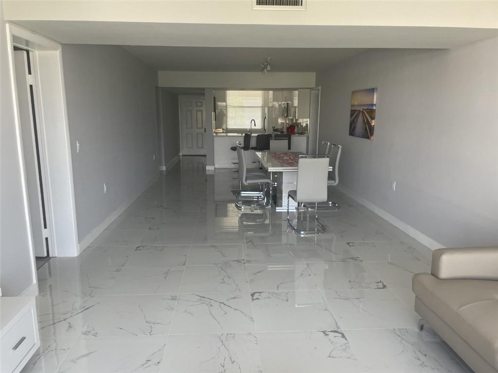 1721 Whitehall Drive, Unit 404 Davie, FL 33324 - Photo 13 of 16 a dining room with furniture and a window
