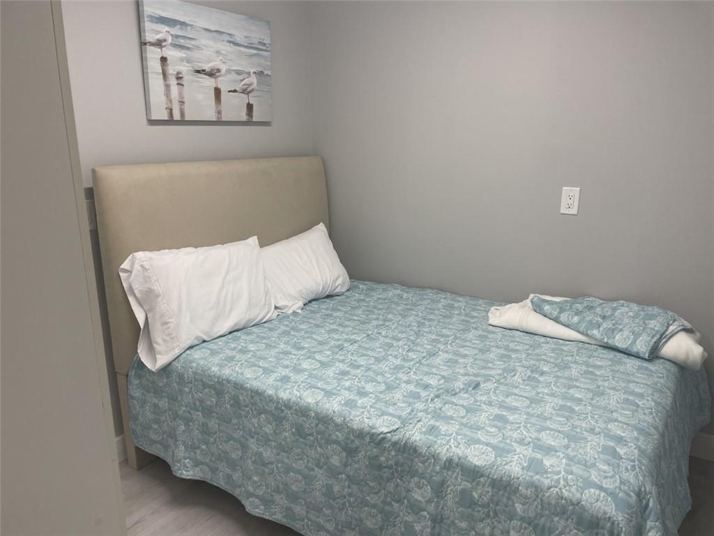 1721 Whitehall Drive, Unit 404 Davie, FL 33324 - Photo 15 of 16 a bedroom with a bed and wall painting