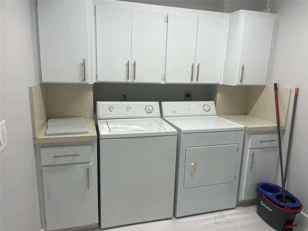 1721 Whitehall Drive, Unit 404 Davie, FL 33324 - Photo 16 of 16 a utility room with dryer and washer