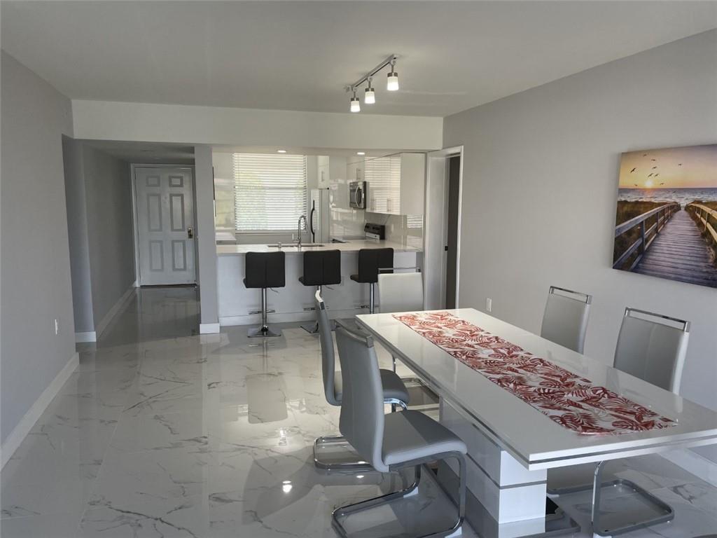 1721 Whitehall Drive, Unit 404 Davie, FL 33324 - Photo 5 of 16 a very nice looking dining room with a table and chairs