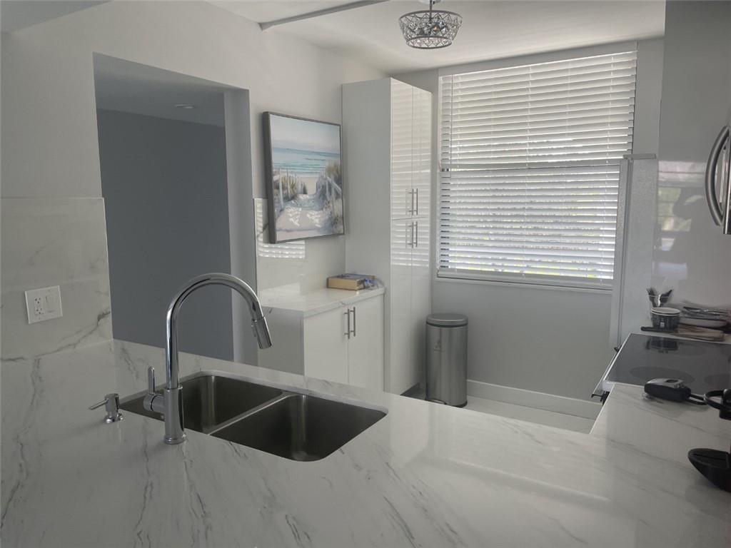 1721 Whitehall Drive, Unit 404 Davie, FL 33324 - Photo 6 of 16 a kitchen with a sink and a window