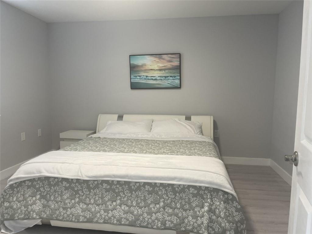 1721 Whitehall Drive, Unit 404 Davie, FL 33324 - Photo 7 of 16 a bedroom with a bed and painting on the wall