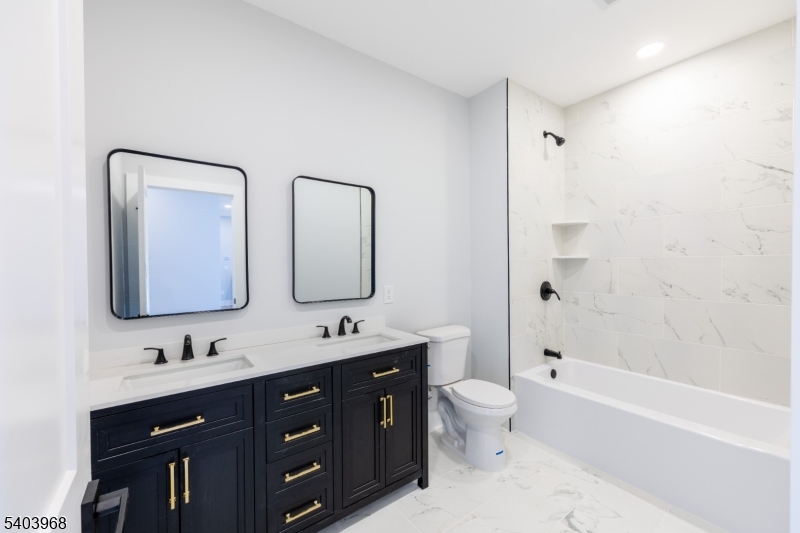 24 Bertrand Island Road Mount Arlington, NJ 07856 - Photo 18 of 44 a bathroom with a double vanity sink mirror double and bathtub