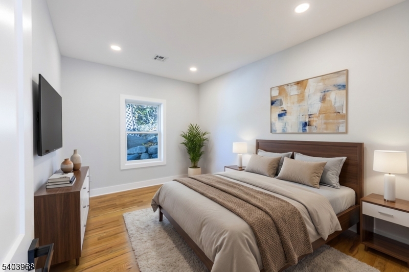 24 Bertrand Island Road Mount Arlington, NJ 07856 - Photo 20 of 44 a bedroom with a bed and a flat screen tv