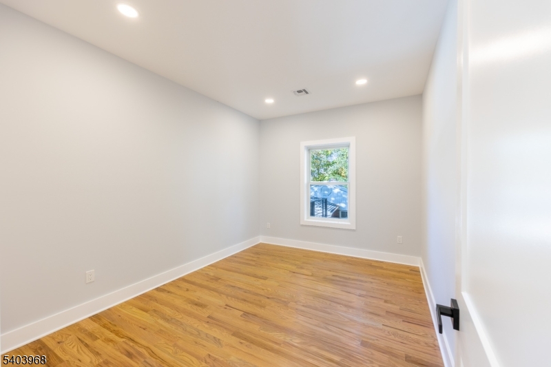24 Bertrand Island Road Mount Arlington, NJ 07856 - Photo 22 of 44 an empty room with wooden floor and windows