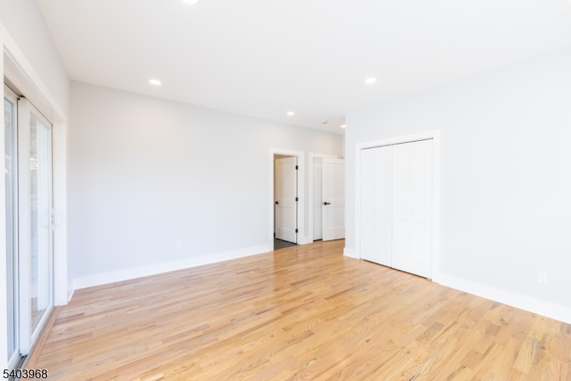 24 Bertrand Island Road Mount Arlington, NJ 07856 - Photo 30 of 44 a view of an empty room with wooden floor