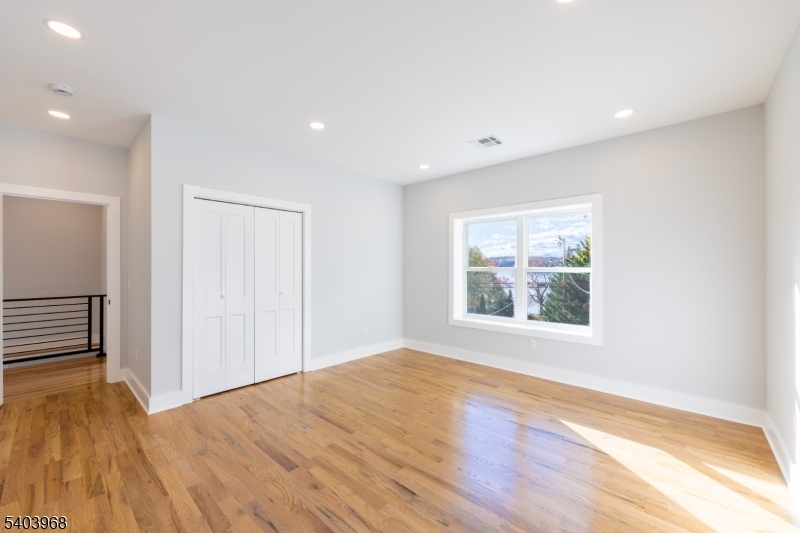 24 Bertrand Island Road Mount Arlington, NJ 07856 - Photo 31 of 44 an empty room with wooden floor and windows