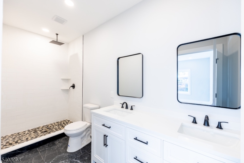 24 Bertrand Island Road Mount Arlington, NJ 07856 - Photo 32 of 44 a bathroom with a toilet sink and mirror