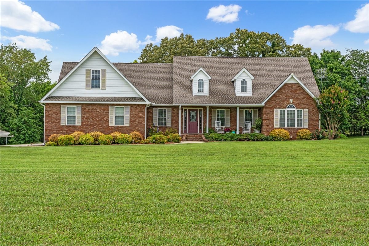 a front view of a house with a garden