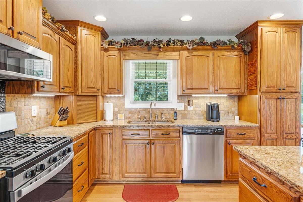 379 Hooper Road Winchester, TN 37398 - Photo 13 of 52 a kitchen with stainless steel appliances granite countertop a stove a sink and a refrigerator
