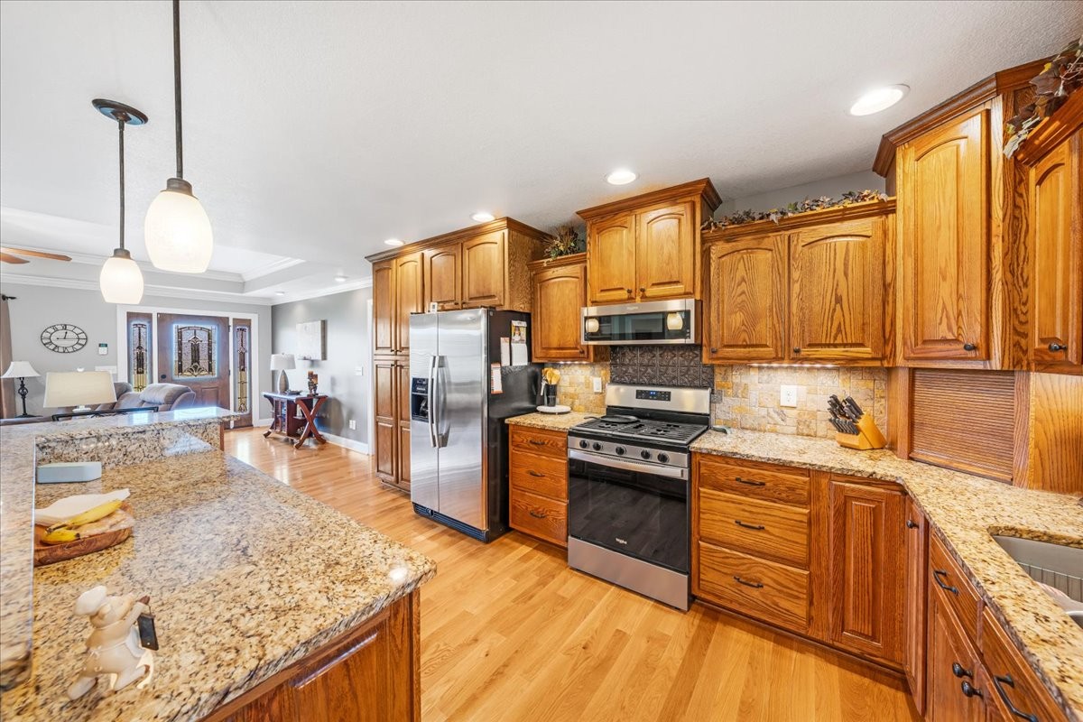 379 Hooper Road Winchester, TN 37398 - Photo 15 of 52 a kitchen with stainless steel appliances granite countertop a sink stove and refrigerator