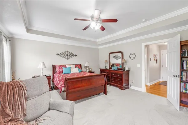 a bedroom with furniture and a ceiling fan