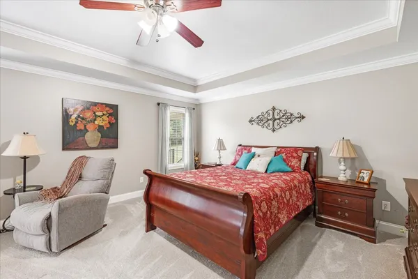 a bedroom with a bed and a chandelier