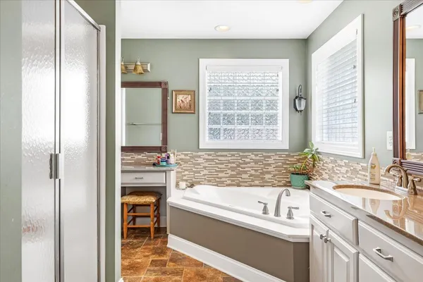 a bathroom with a bathtub and a sink