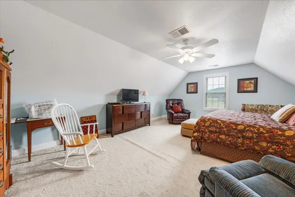 a bedroom with furniture and a chandelier