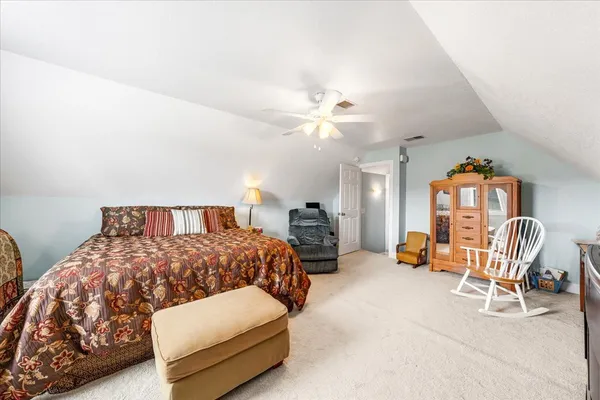 a bedroom with a bed chair and couch