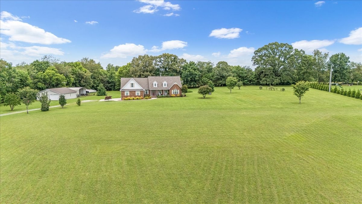 379 Hooper Road Winchester, TN 37398 - Photo 46 of 52 a building view with swimming pool and trees in the background