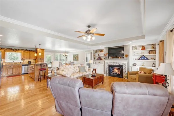 a living room with furniture fireplace and a large window