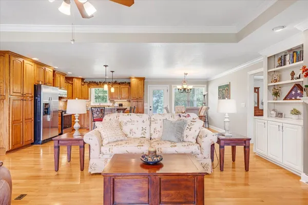 a living room with furniture wooden floor and a large window