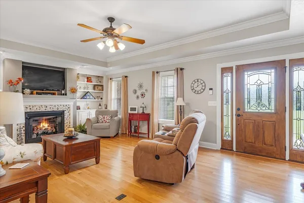 a living room with furniture a flat screen tv and a fireplace