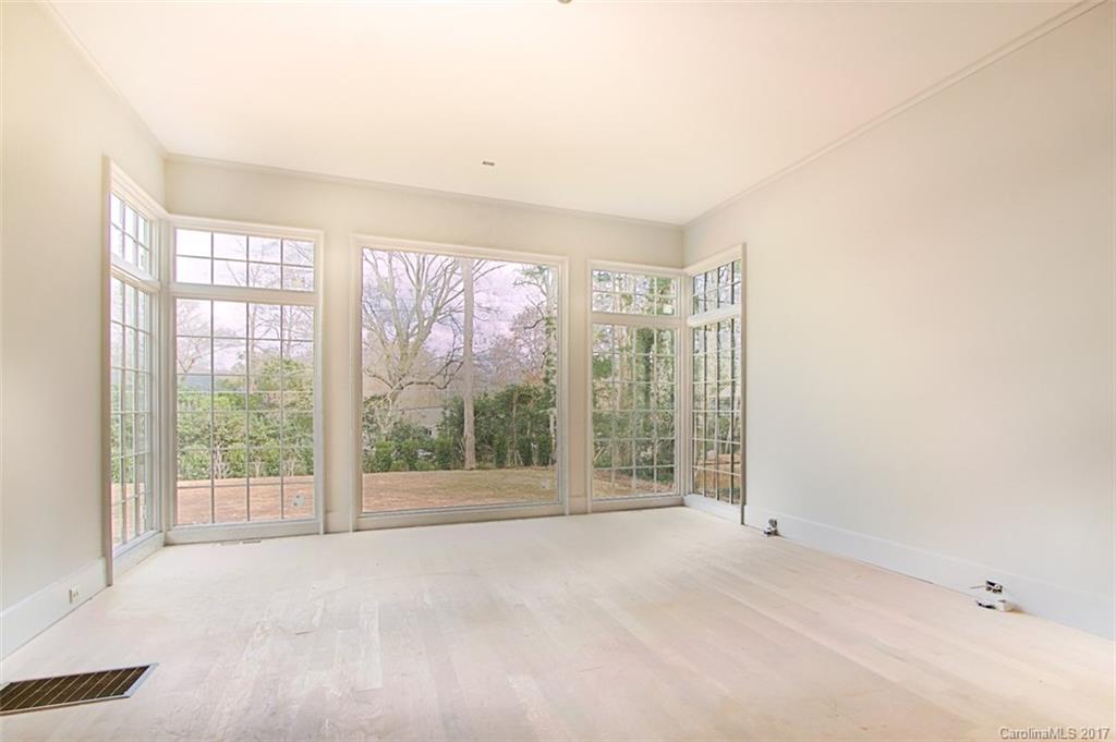 3935 Abingdon Road Charlotte, NC 28211 - Photo 20 of 23 a view of an empty room with wooden floor and a window