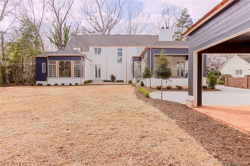 3935 Abingdon Road Charlotte, NC 28211 - Photo 5 of 23 a view of a house with a yard covered in snow