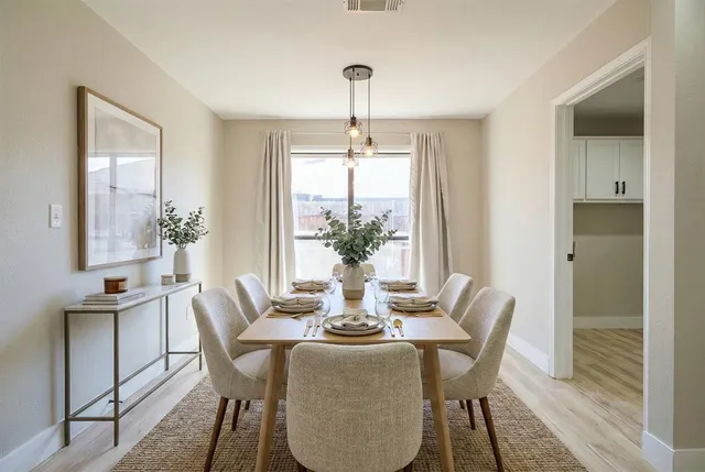 a bedroom with a large bed a chandelier and windows