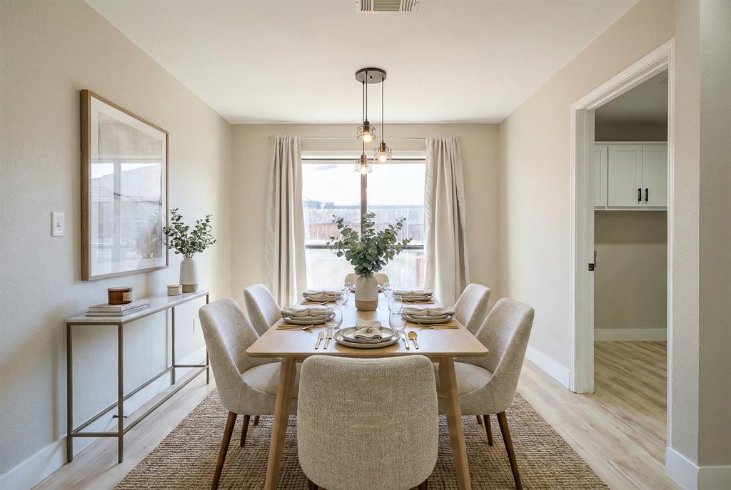 621 Main Street Roanoke, TX 76262 - Photo 13 of 30 a dining room with furniture potted plants and wooden floor