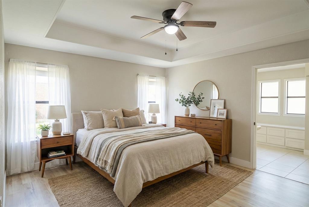 621 Main Street Roanoke, TX 76262 - Photo 14 of 30 a bedroom with a large bed a chandelier and windows
