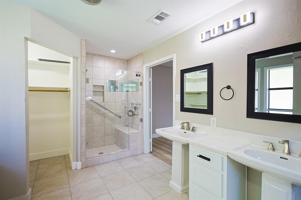 621 Main Street Roanoke, TX 76262 - Photo 16 of 30 a bathroom with a double vanity sink mirror and shower