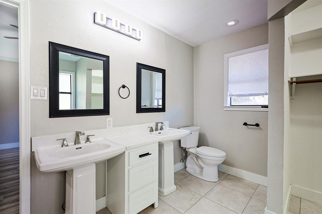 621 Main Street Roanoke, TX 76262 - Photo 17 of 30 a bathroom with a toilet sink and mirror