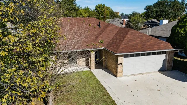 an aerial view of houses with yard