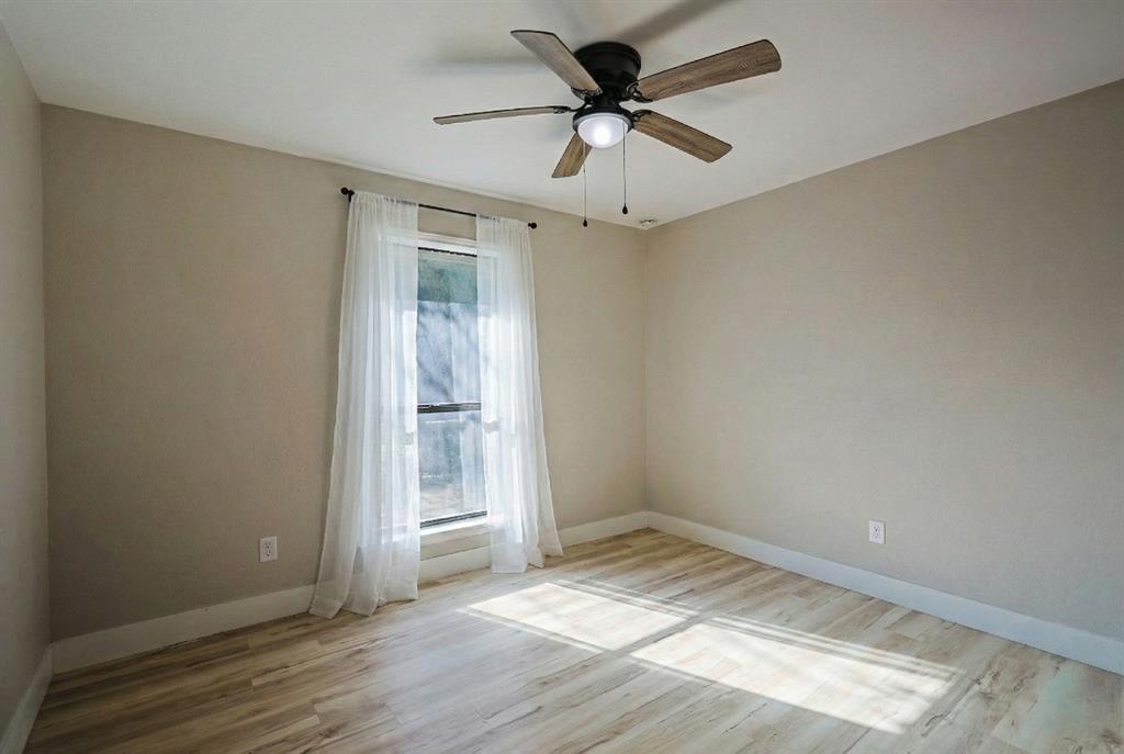 621 Main Street Roanoke, TX 76262 - Photo 22 of 30 an empty room with wooden floor and windows