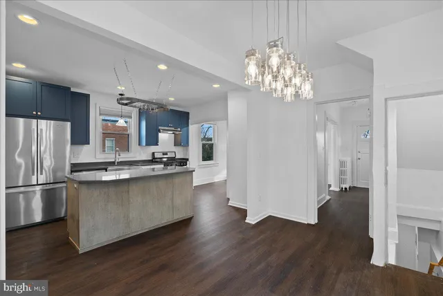 a kitchen with stainless steel appliances granite countertop a refrigerator and a stove top oven