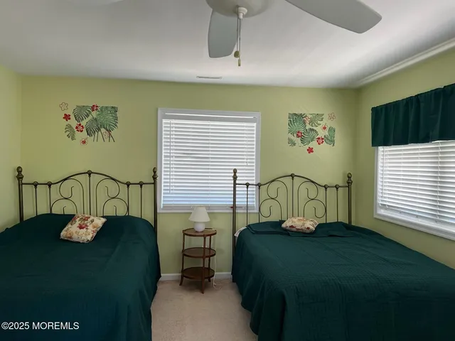 a view of a dining room with a table and chairs
