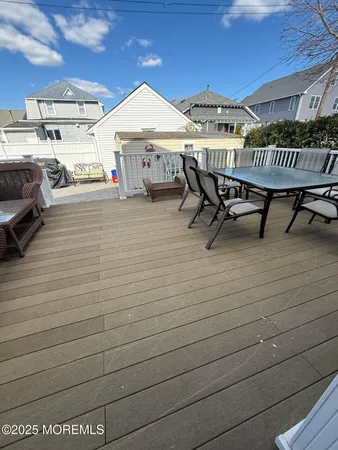 a roof deck with table and chairs