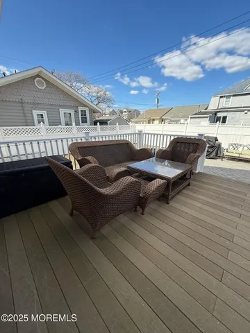 a roof deck with table and chairs