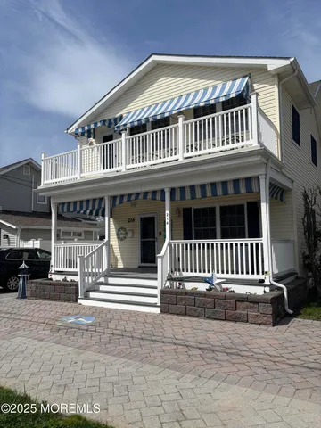 a view of front of house with a balcony