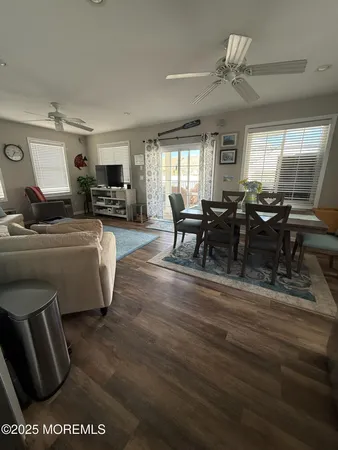 a living room with furniture wooden floor and a window