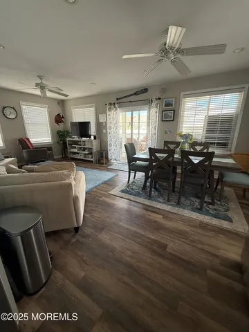a living room with furniture wooden floor and a window