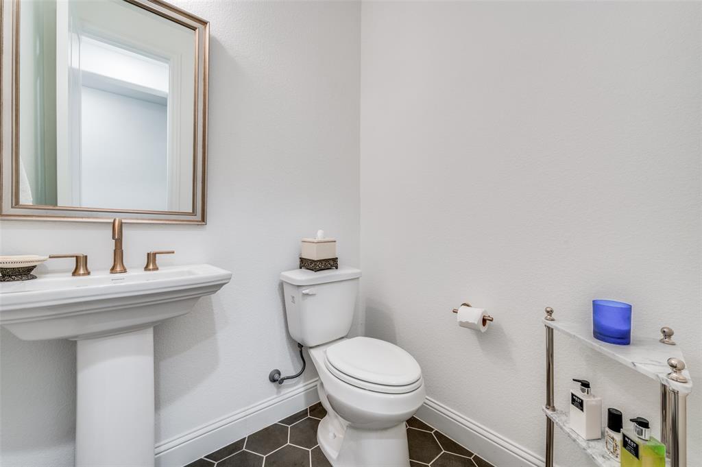 2390 Red Cedar Trail Prosper, TX 75078 - Photo 21 of 40 a bathroom with a sink a toilet and mirror