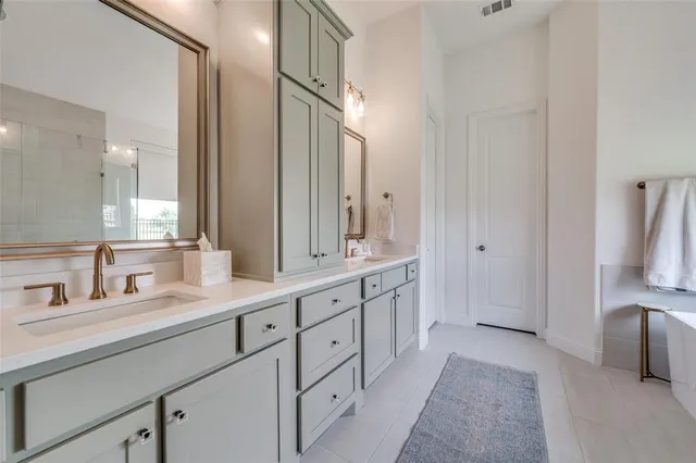 a spacious bathroom with a double vanity sink and a mirror