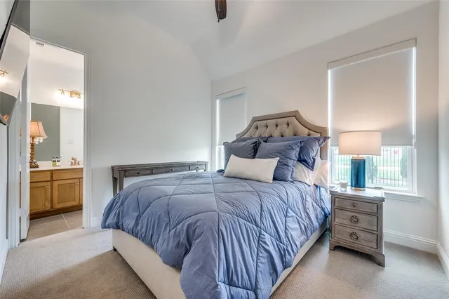 a bedroom with a bed and a view of en suite bathroom