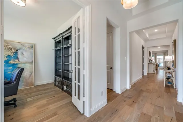 a view of a hallway to a livingroom with furniture