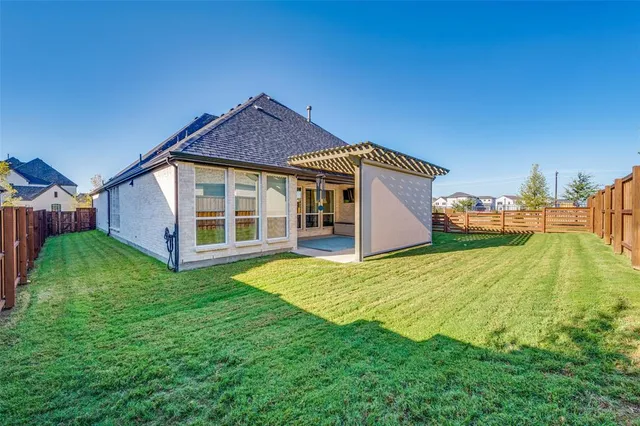 a view of an house with backyard space and balcony